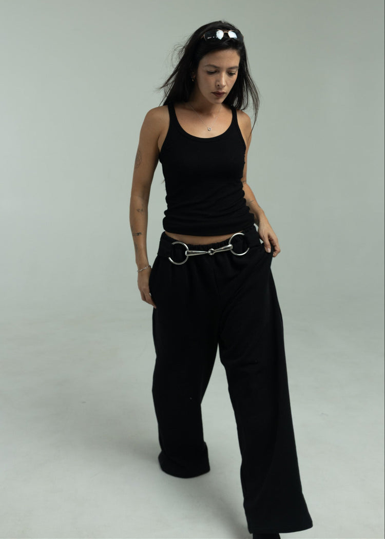Model wearing black pants walking towards the camera