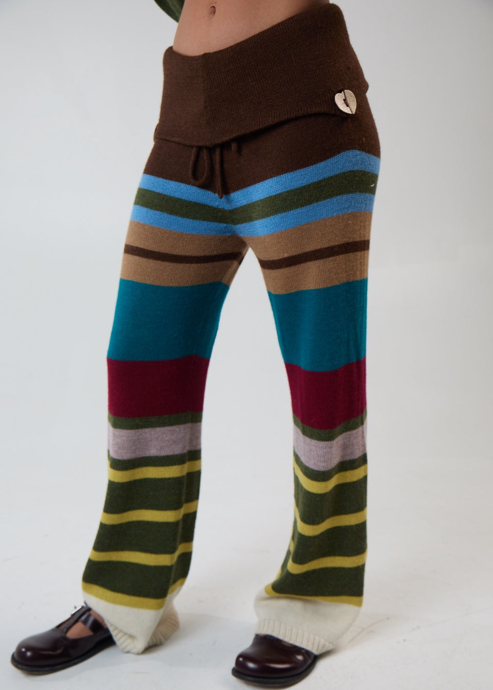 Model wearing multi-stripe pants, main photo default