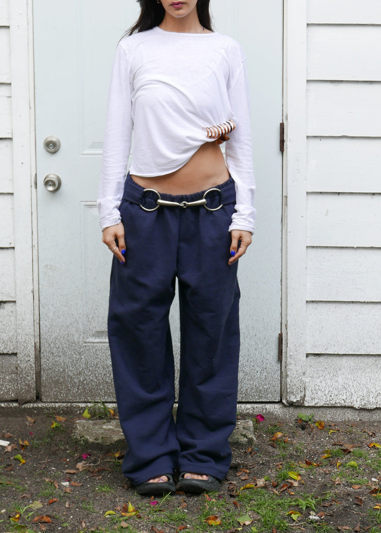 Model wearing midnight pants in front of a door