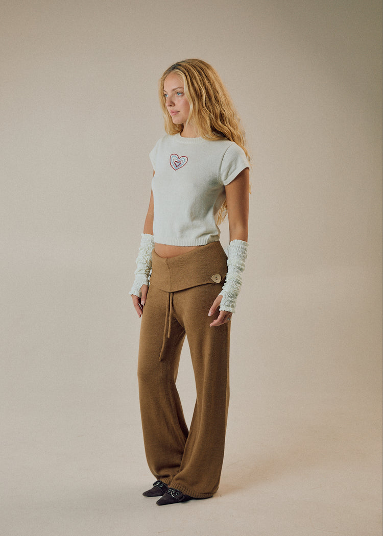 Model wearing camel pants