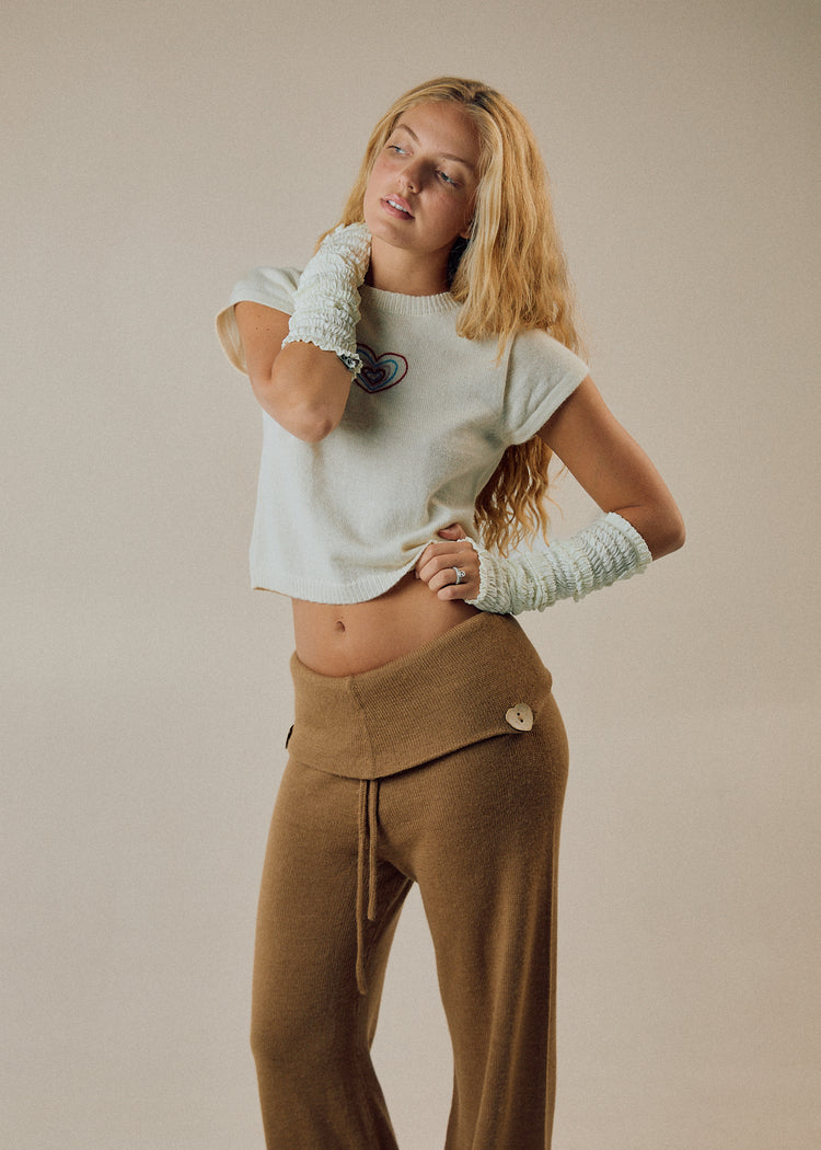Model wearing camel pants