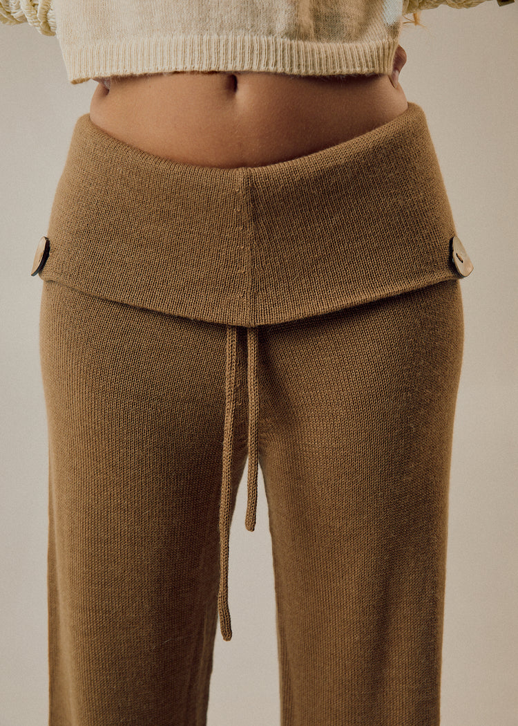 Model wearing camel pants