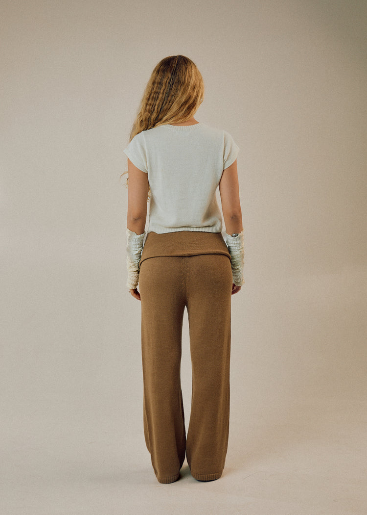 Model wearing camel pants