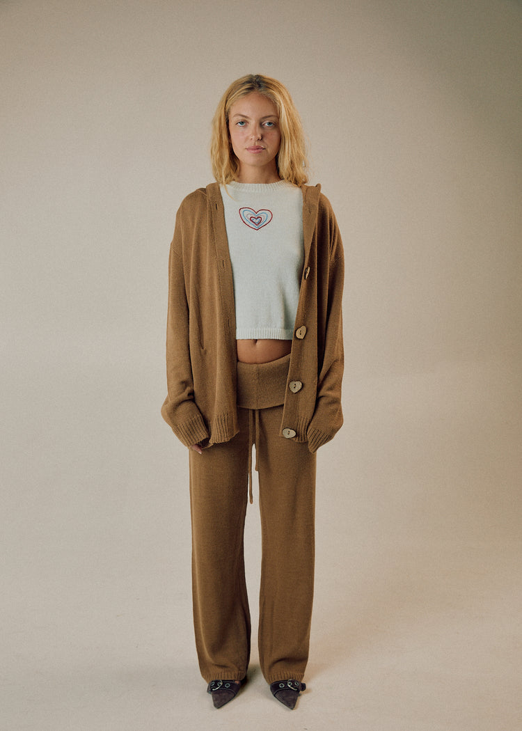 Model in camel cardigan