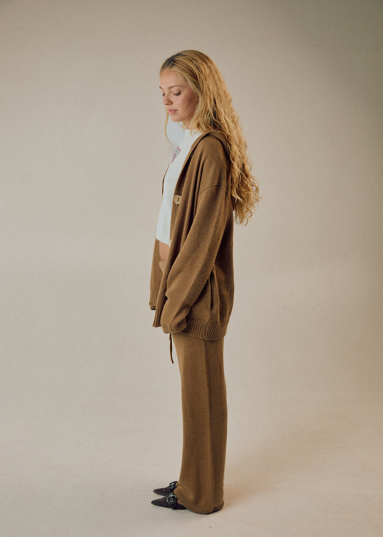 Model in camel cardigan