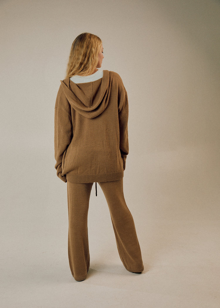 Model in camel cardigan