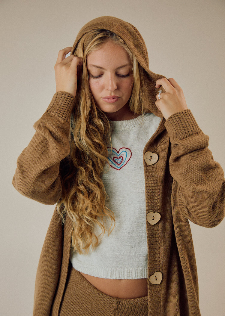 Model in camel cardigan
