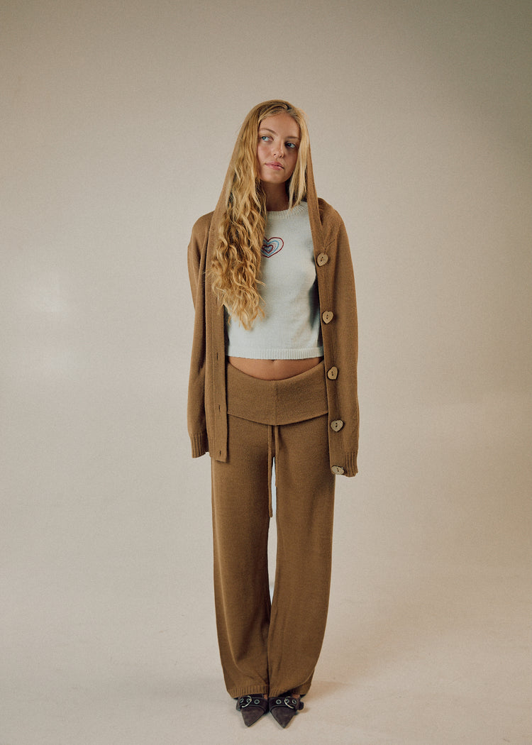 Model wearing camel pants