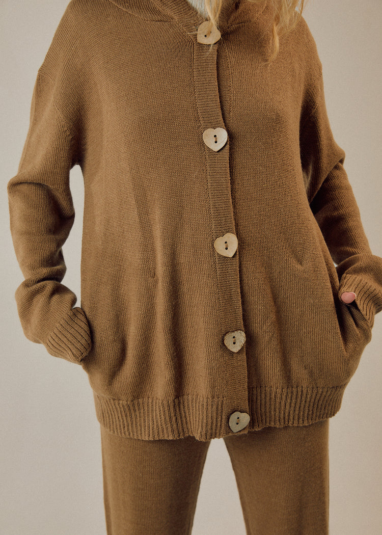 Model in camel cardigan