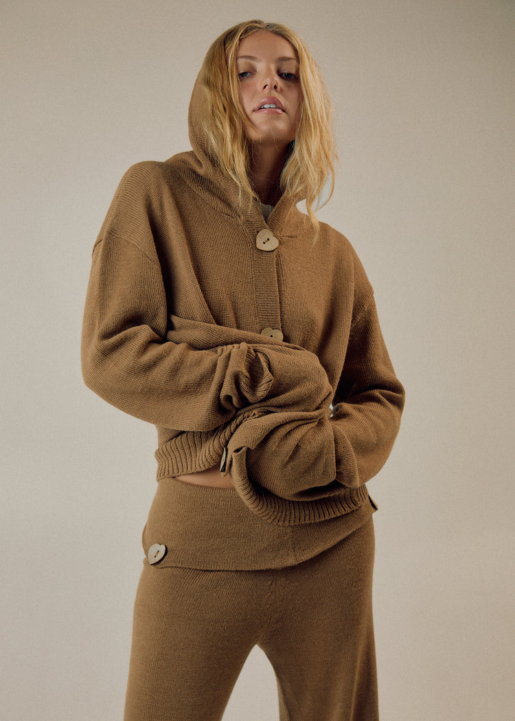Model in camel cardigan